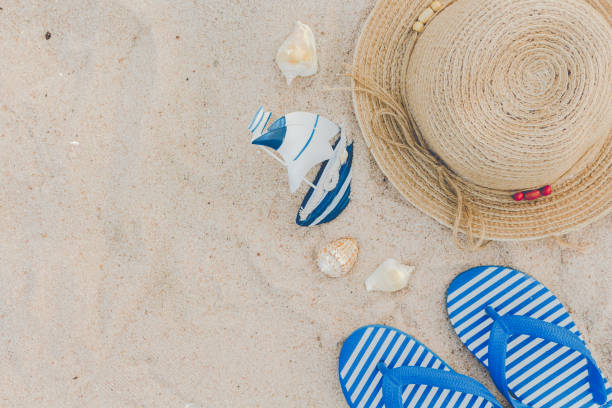 istock Straw hat and flip flops on a tropical beach 823103252
