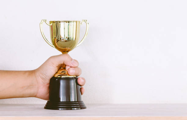 istock Golden trophy on wooden table with copy space 823103908
