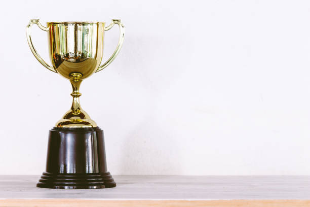 istock Golden trophy on wooden table with copy space 823103916