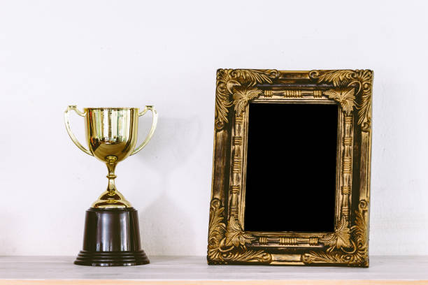 istock Golden trophy on wooden table with copy space 823103982