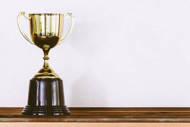 istock Golden trophy on wooden table with copy space 823104052