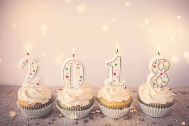 istock 2018 Happy New Year Cupcakes with fairy light toning background 823105340