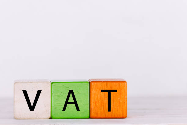istock VAT Concept with wooden block with stacked coins 823110058