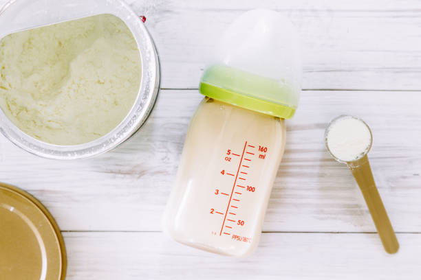 istock Feeding bottles and baby milk on wooden table 823110848