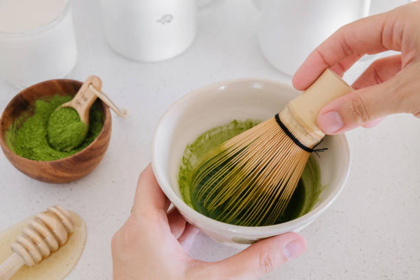 istock making Matcha green tea latte, healthy trendy drinks 823112556