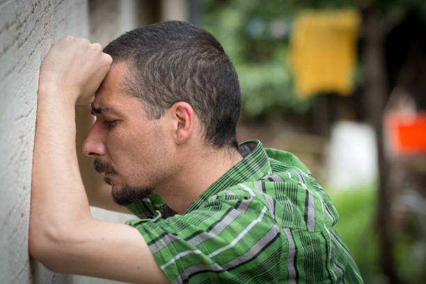 istock Depressed and desperate man leaning against the wall 823112812