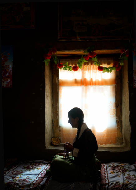 istock woman praying with prayer roll in Lhasa 823160584