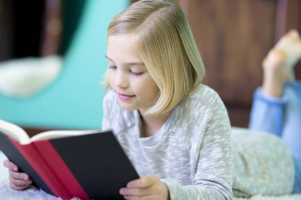istock Girl reading on floor 823181652