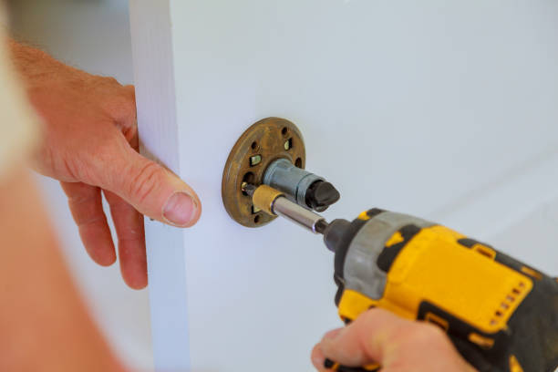 istock carpenter lock installation with electric drill into interior wood door 823182046