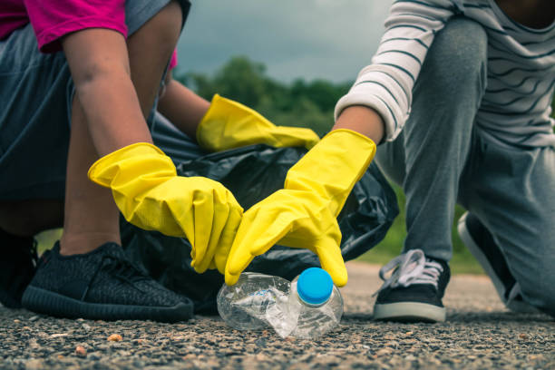 istock Group of kids volunteer help garbage collection charity environment. 823201546