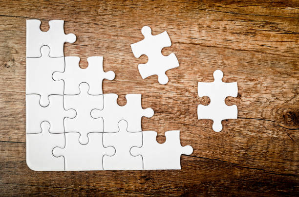 istock Placing missing piece of puzzle 823225316