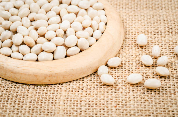 istock white beans seeds in wooden dish 823225406