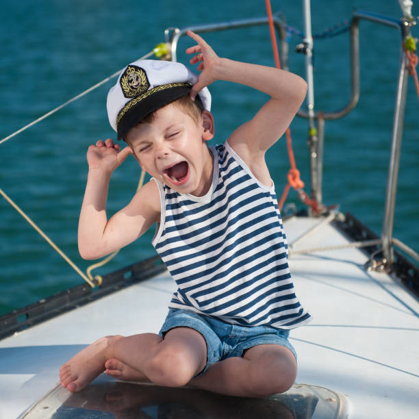 istock funny little boy wearing captain hat sitting aboard luxury boat 823234614