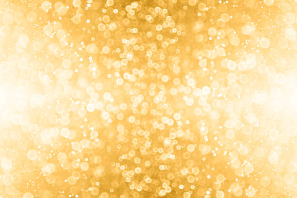 Abstract Gold Glitter and Golden Sparkle Background Abstract gold glitter sparkle confetti background or golden party invite for happy birthday, 50th anniversary, champagne color banner, New Year’s Eve bash, Christmas blur, engagement or bridal texture 50th anniversary photos stock pictures, royalty-free photos & images
