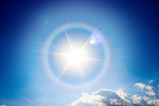 Beautiful fantastic sun halo phenomenon in sky, Miraculous sun with circular rainbow.