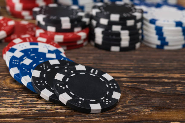 istock Poker chips scattered on the background of a wooden table 823252026