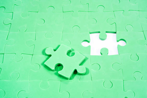 istock Background of green puzzles without one 823259290