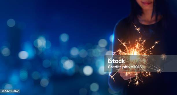 Female Playing Sparklers During Celebration Stock Photo - Download Image Now - Sparkler - Firework, Christmas, Sparks