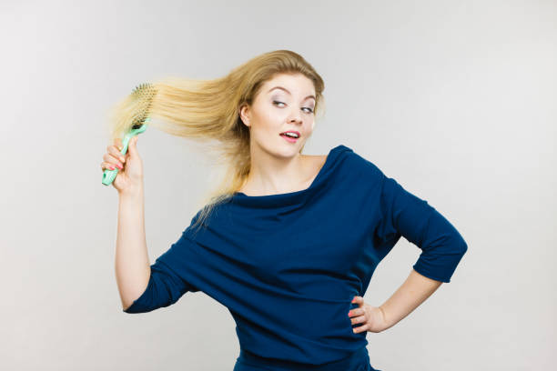 istock Woman brushing her long hair with brush 823262646