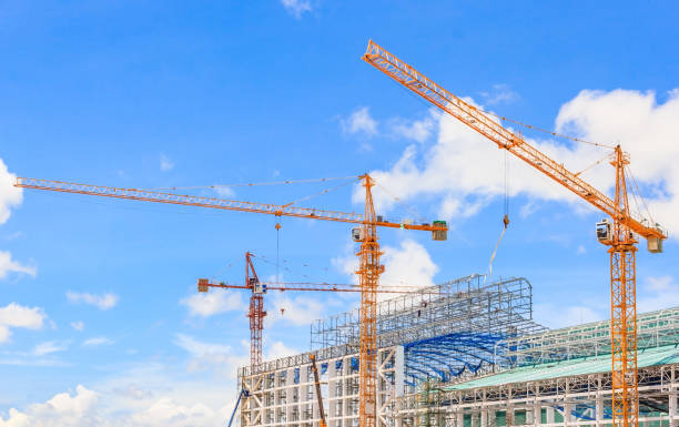 istock Construction site. Construction cranes and high-rise building under construction against blue sky 823267480