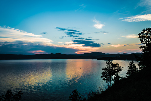 Lake Turgoyak at sunset from the height of the mountains. The lake is located between the mountains of the Ural range.