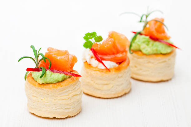 salted  puff pastry stuffed with cream cheese and smoked salmon on white background - vol au vent imagens e fotografias de stock