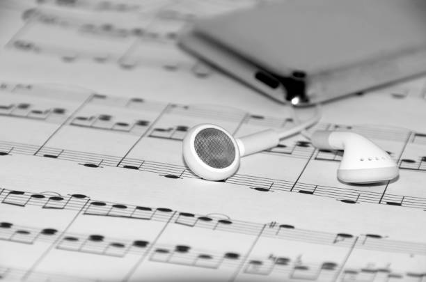 istock Concept with ear phones on musical notes. Monochrome photo. 823284254