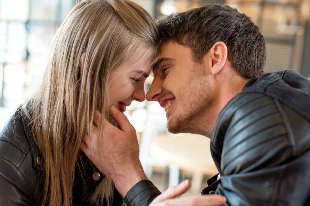 istock side view of young man kissing beautiful girlfriend 823293326