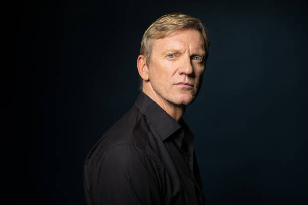 istock Side View Of Serious Man Against Black Background 823303820