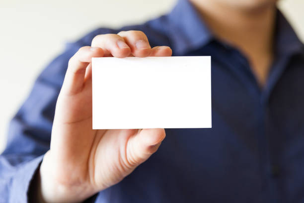 istock business man holding business name card 823304720