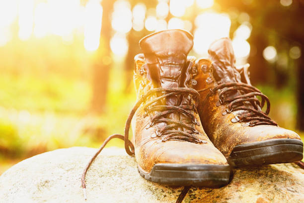 istock Well-worn hiking boots sit on a sunny rock 823307300