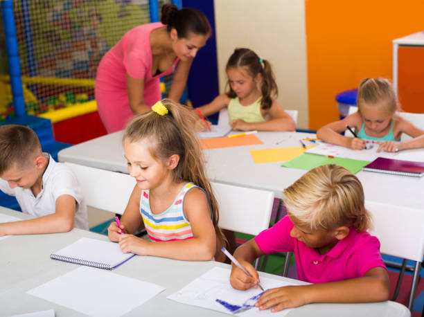 istock children sitting together and studying in class at school 823308126