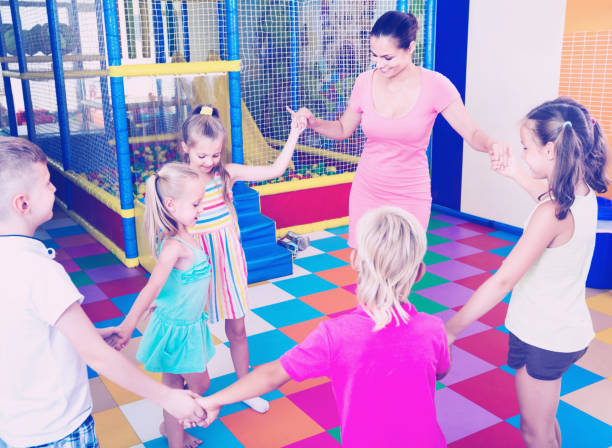 istock Kids dancing with teacher in  school class 823308316