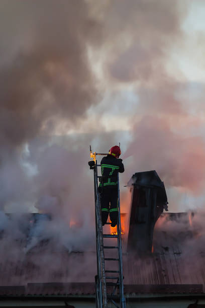Firefighter operation team using water for reduce fire sprinkler.Destruction with equipment fire extnguisher.