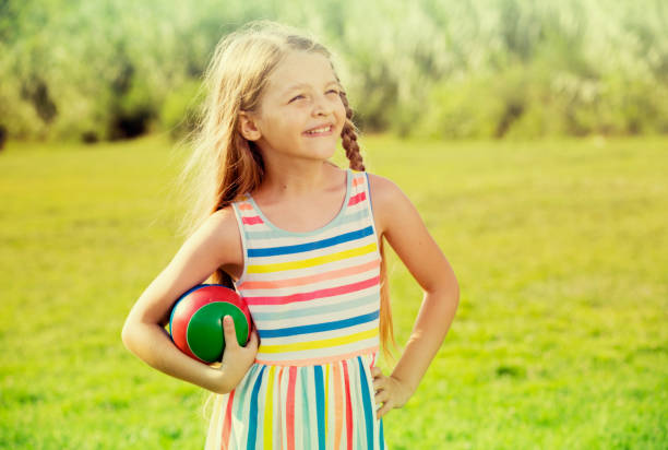 istock smiling girl with ball 823311542