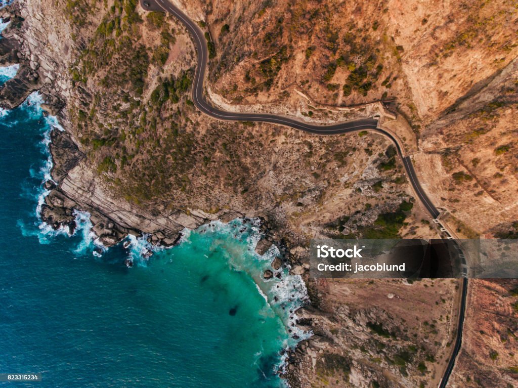 Chapmans Peak Drive Aerial view of road going through beautiful landscape. Rocky scenery close to the ocean. Cape Town Stock Photo