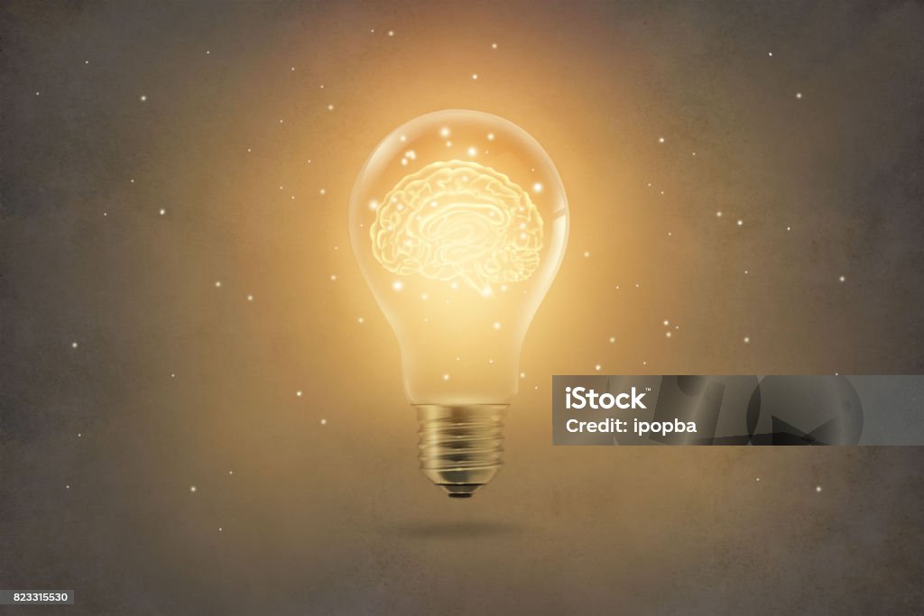 golden brain glowing inside of light bulb on paper texture background Light Bulb Stock Photo