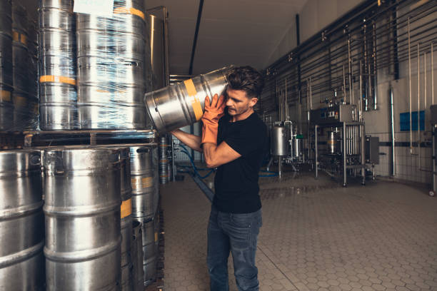 istock Brewer with keg at brewery factory warehouse 823318542
