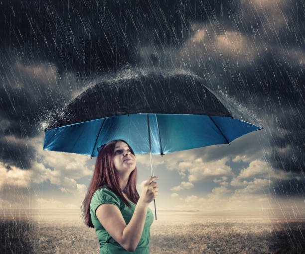 istock Young girl holding an umbrella 823319264