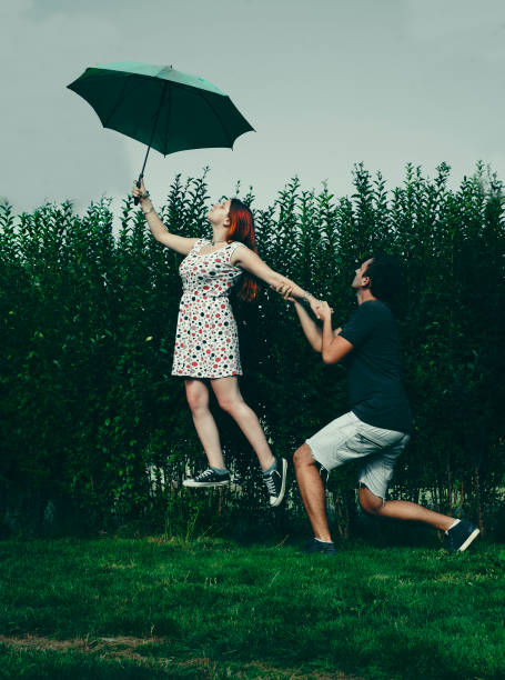 istock Woman taking off from the ground with an umbrella 823319414