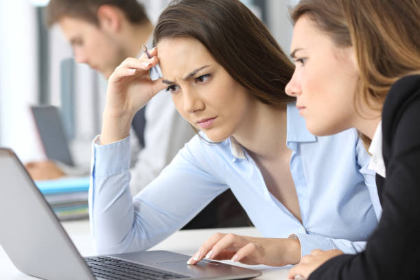 istock Worried businesswomen working on line 823326508