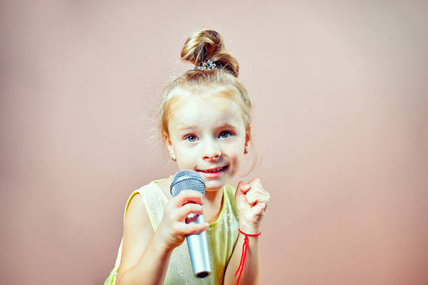 istock The child sings into the microphone 823326664