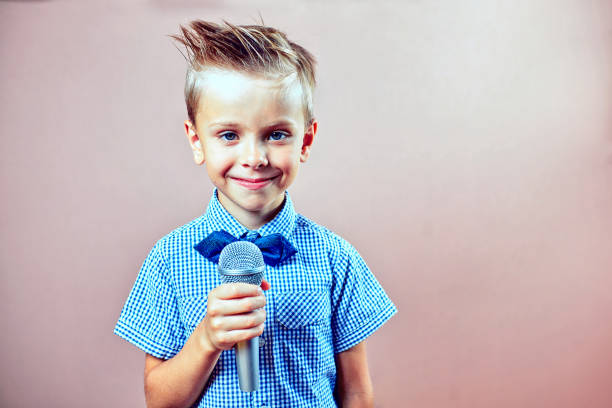 istock The child sings into the microphone 823326666