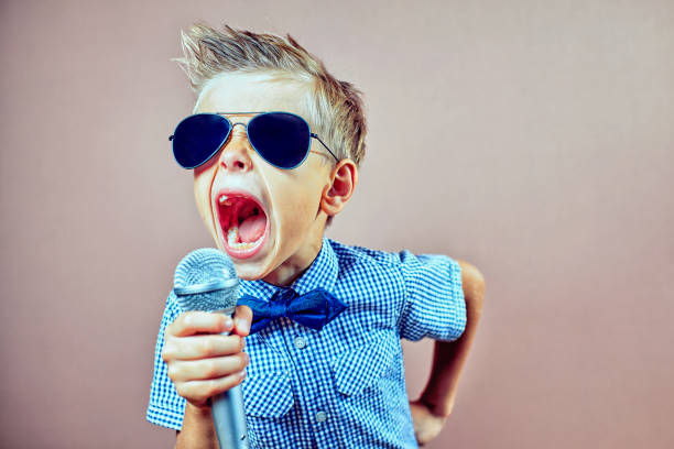 istock The child sings into the microphone 823326682