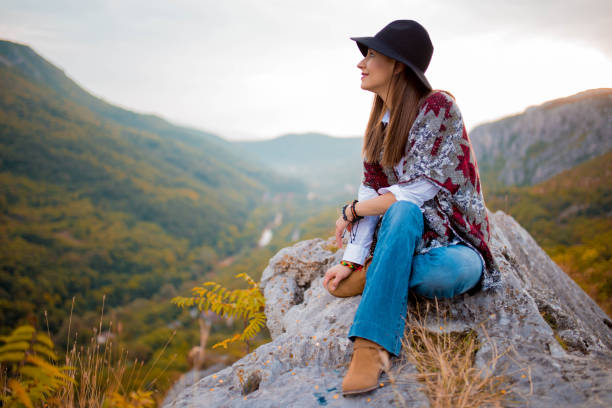 istock Girl resting on mountain rock 823326972