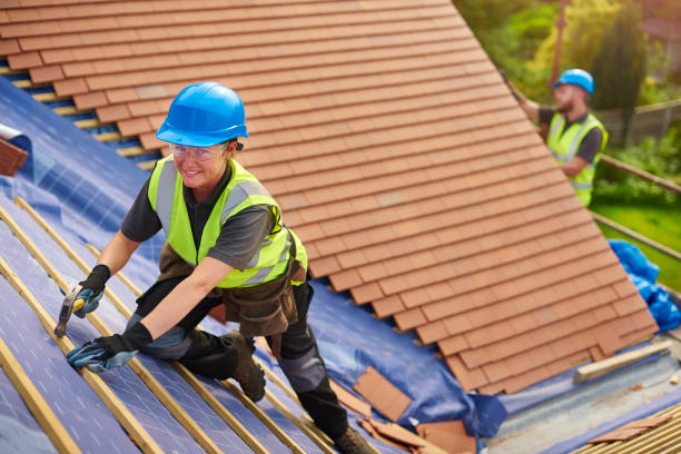 istock female roofer installing new roof tiles 823335118