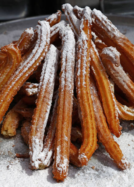 istock Sweet fresh churros snack with sugar close up 823344776