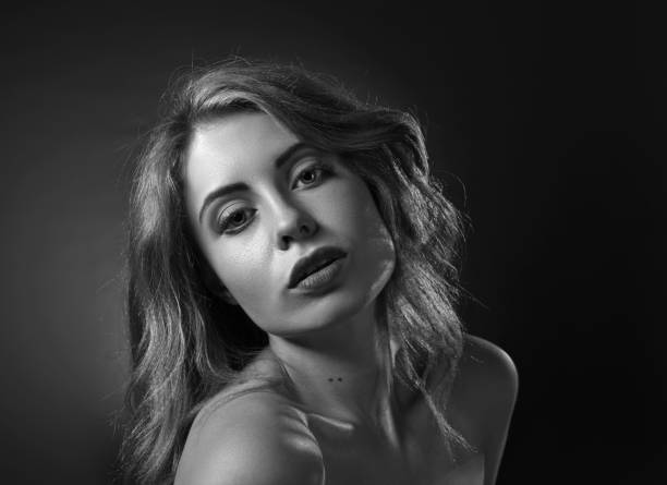 istock Attractive blonde woman on dark background . 823347798