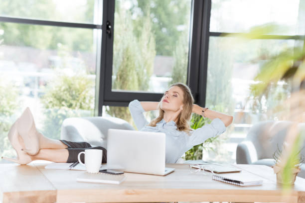 istock young businesswoman resting during work at workplace with laptop in office 823348192
