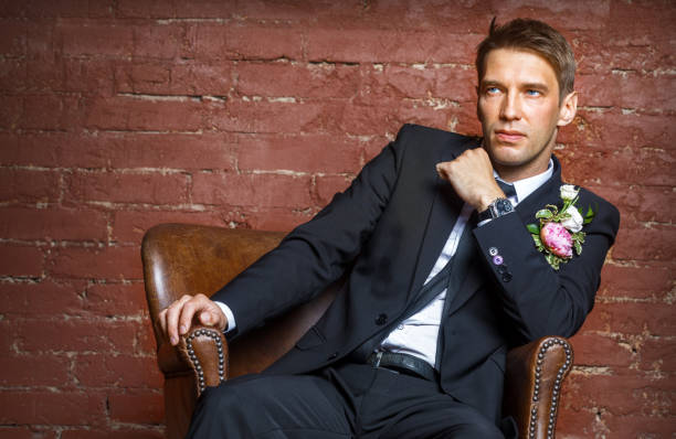 istock serious groom sits in a leather chair 823348546